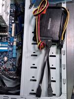 Two SATA SSDs in a bracket with a 6-pin PCIe power adapter